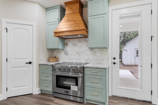 600 Arthur St, Mcgregor, TX 76657 - kitchen featuring high end stainless steel range oven, custom exhaust hood, green cabinetry, and dark wood finished floors