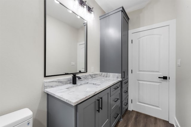 600 Arthur St, Mcgregor, TX 76657 - half bathroom with wood finished floors, vanity, and toilet