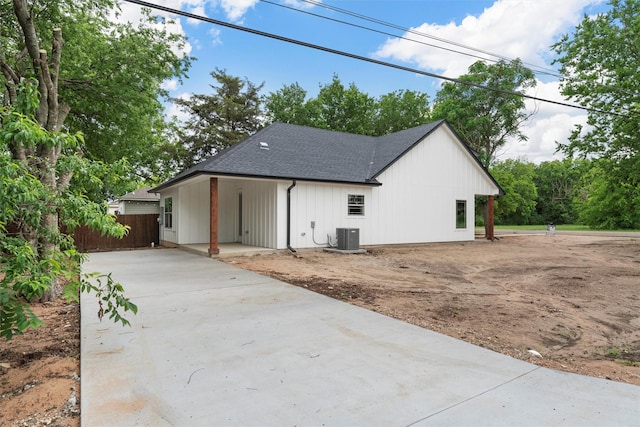 600 Arthur St, Mcgregor, TX 76657 - view of side of home featuring cooling unit, driveway, a shingled roof, and fence
