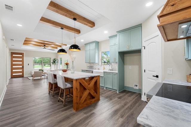 600 Arthur St, Mcgregor, TX 76657 - kitchen with a raised ceiling, dark wood-type flooring, recessed lighting, decorative backsplash, and beamed ceiling