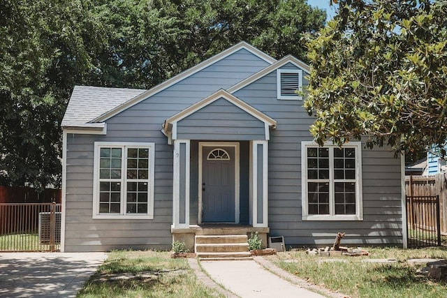 bungalow-style house with fence and roof with shingles