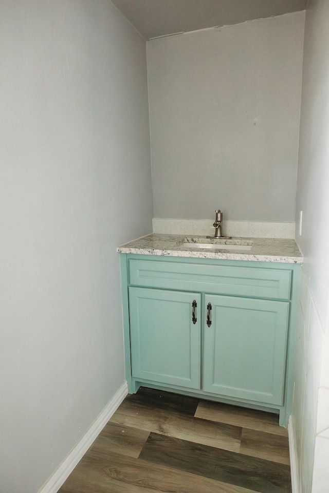 bathroom with vanity and wood finished floors