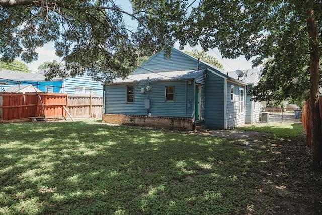 back of house featuring central air condition unit