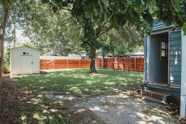 view of yard featuring a storage shed and an outbuilding