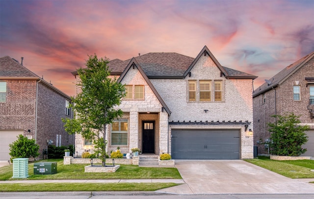 6108 Lipan Ln, Mckinney, TX 75070 - french country inspired facade with stone siding, an attached garage, concrete driveway, and central AC