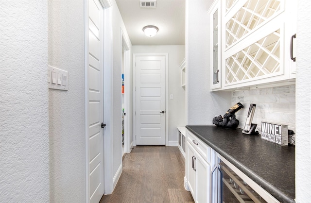 6108 Lipan Ln, Mckinney, TX 75070 - indoor dry bar featuring dark wood-style flooring, beverage cooler, backsplash, and baseboards