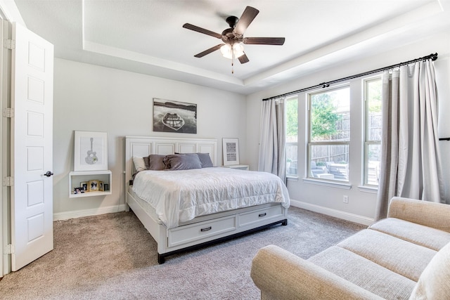 6108 Lipan Ln, Mckinney, TX 75070 - bedroom featuring a tray ceiling, carpet floors, baseboards, and a ceiling fan
