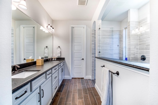 6108 Lipan Ln, Mckinney, TX 75070 - bathroom with a walk in shower, wood finished floors, baseboards, and double vanity