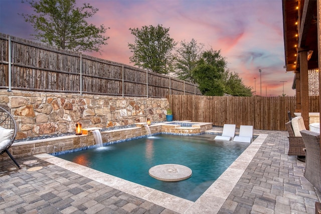6108 Lipan Ln, Mckinney, TX 75070 - pool at dusk with a fenced backyard, an in-ground hot tub, and a patio area