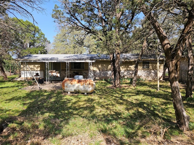 193 County Road 1704, Clifton, TX 76634 - back of property featuring a lawn and an attached garage