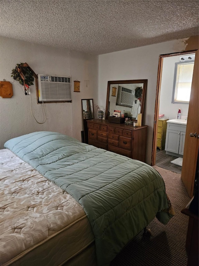 193 County Road 1704, Clifton, TX 76634 - bedroom featuring a textured ceiling, an AC wall unit, and a sink