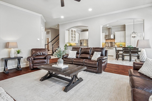 8001 Sutherland Ln, Plano, TX 75025 - living area with wood finished floors, arched walkways, a ceiling fan, recessed lighting, and stairway