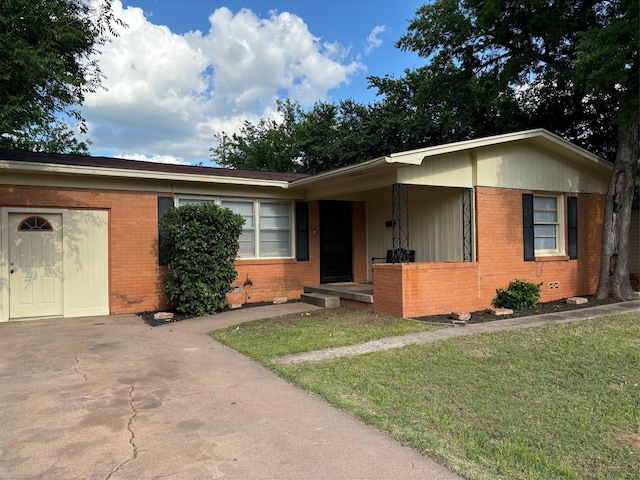 ranch-style home with brick siding and a front lawn