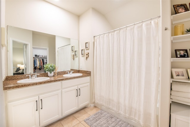 9332 Castorian Dr, Fort Worth, TX 76131 - bathroom featuring tile patterned floors, double vanity, a shower with shower curtain, and a spacious closet