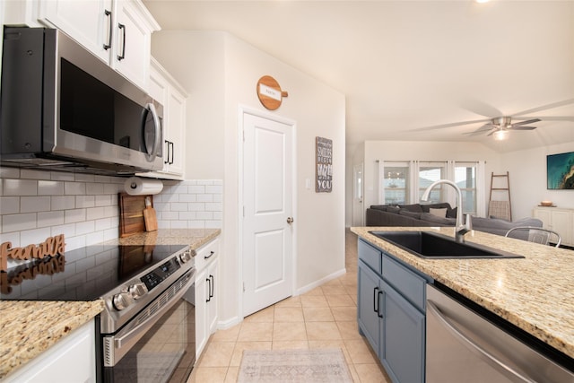 9332 Castorian Dr, Fort Worth, TX 76131 - kitchen featuring stainless steel appliances, a sink, open floor plan, decorative backsplash, and white cabinets