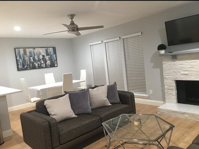 5881 Preston View Blvd Unit 121, Dallas, TX 75240 - living room with a ceiling fan, light wood finished floors, baseboards, and a fireplace