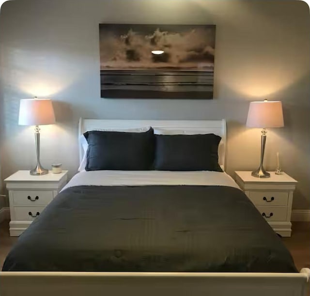 5881 Preston View Blvd Unit 121, Dallas, TX 75240 - bedroom with baseboards and dark wood-style flooring