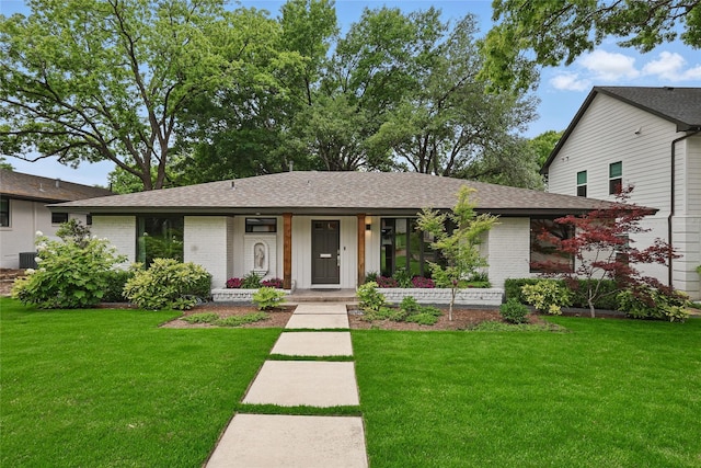 11641 Sasanqua Ln, Dallas, TX 75218 - view of front of house featuring brick siding, a front yard, a shingled roof, and central AC