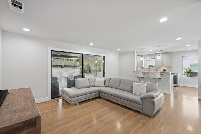 11641 Sasanqua Ln, Dallas, TX 75218 - living area with light wood-style flooring, recessed lighting, baseboards, and beverage cooler