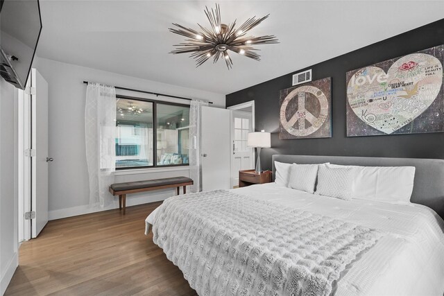 11641 Sasanqua Ln, Dallas, TX 75218 - bedroom featuring wood finished floors, baseboards, and a chandelier