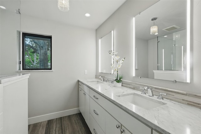 11641 Sasanqua Ln, Dallas, TX 75218 - bathroom with wood finished floors, baseboards, double vanity, recessed lighting, and a shower