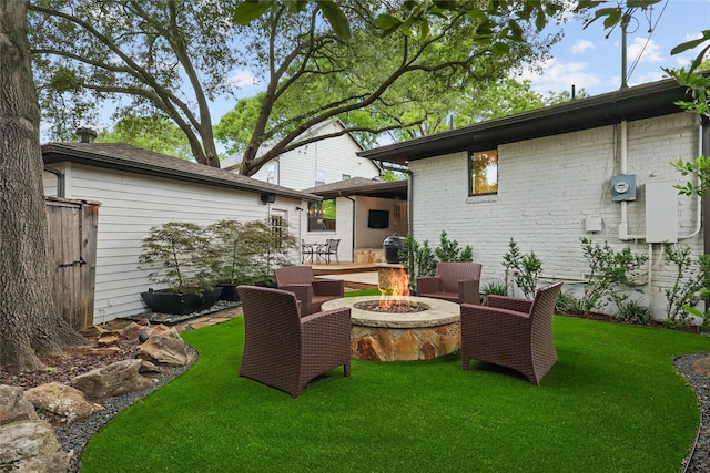 11641 Sasanqua Ln, Dallas, TX 75218 - rear view of house featuring an outdoor fire pit, a lawn, and brick siding