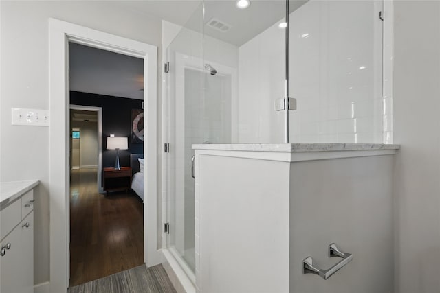 11641 Sasanqua Ln, Dallas, TX 75218 - ensuite bathroom featuring wood finished floors and tiled shower
