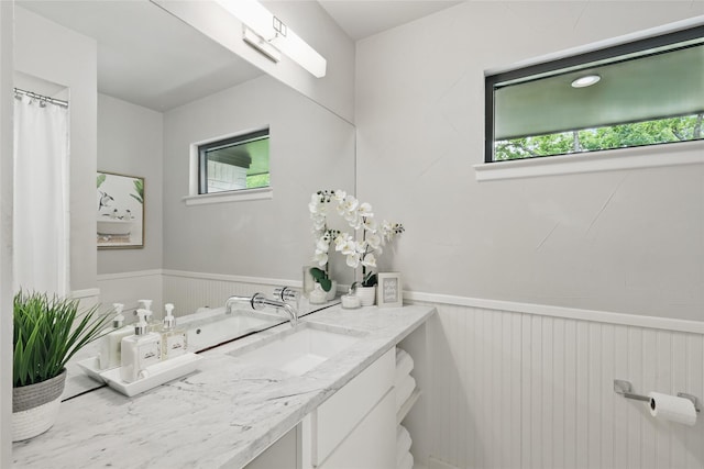 11641 Sasanqua Ln, Dallas, TX 75218 - full bath featuring a wainscoted wall, plenty of natural light, and vanity