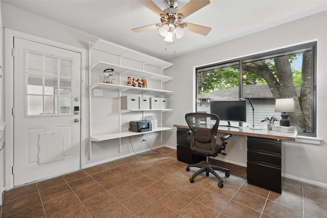 11641 Sasanqua Ln, Dallas, TX 75218 - office space featuring dark tile patterned flooring, ceiling fan, baseboards, and built in desk
