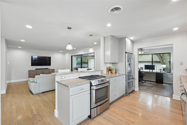 11641 Sasanqua Ln, Dallas, TX 75218 - kitchen with appliances with stainless steel finishes, an office area, a peninsula, light stone countertops, and light wood finished floors
