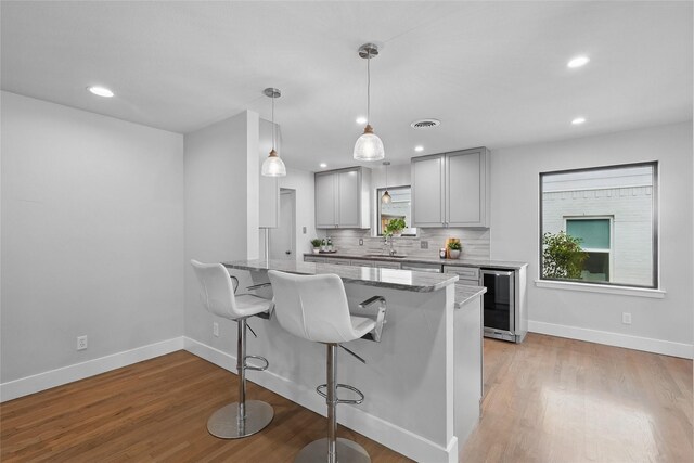 11641 Sasanqua Ln, Dallas, TX 75218 - kitchen with baseboards, light stone countertops, gray cabinetry, a sink, and recessed lighting