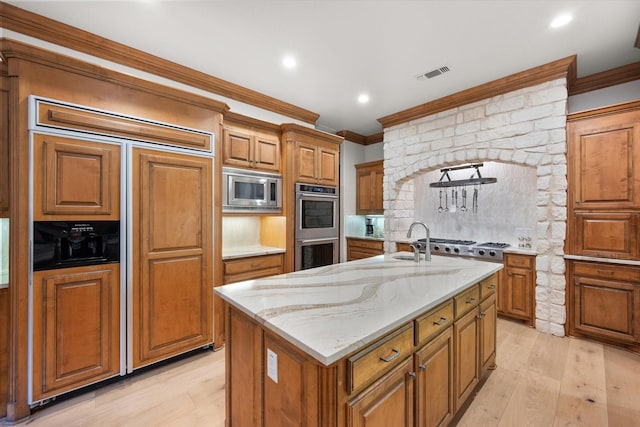 520 Round Hollow Ln, Southlake, TX 76092 - kitchen with crown molding, built in appliances, brown cabinets, light wood finished floors, and recessed lighting