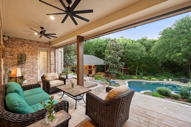 view of patio / terrace with an outdoor living space with a fireplace, a ceiling fan, an outdoor pool, and a wooden deck