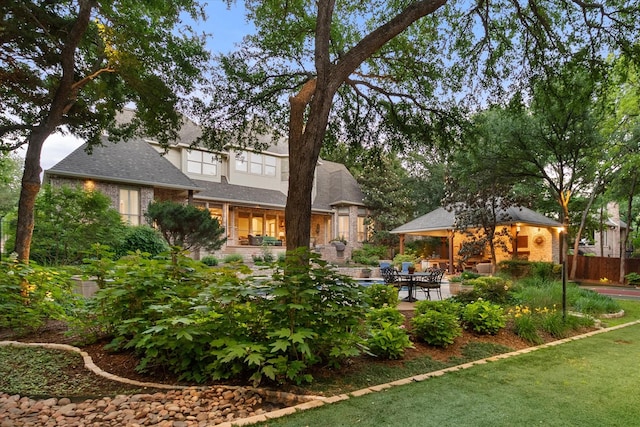 back of house featuring a patio, brick siding, and a gazebo