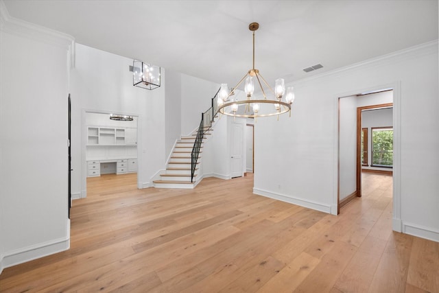 520 Round Hollow Ln, Southlake, TX 76092 - unfurnished dining area featuring a chandelier, stairway, light wood-type flooring, crown molding, and built in study area