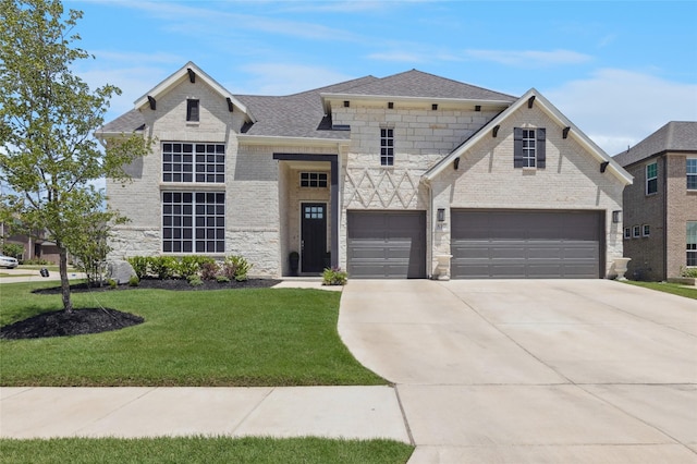 810 Brenda Dr, Mansfield, TX 76063 - french country home featuring a front lawn, concrete driveway, a garage, and stone siding
