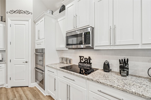 810 Brenda Dr, Mansfield, TX 76063 - kitchen with stainless steel appliances, white cabinets, decorative backsplash, light wood-style floors, and light stone counters
