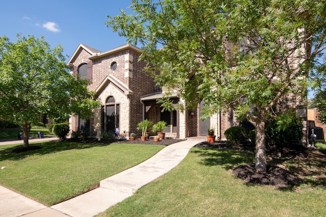6001 Lacebark Elm Dr, Fort Worth, TX 76123 - view of front of home featuring brick siding, a front yard, and stone siding