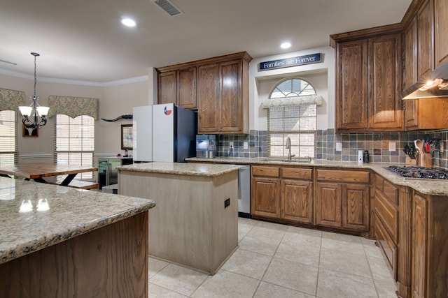 6001 Lacebark Elm Dr, Fort Worth, TX 76123 - kitchen with a sink, a center island, appliances with stainless steel finishes, tasteful backsplash, and crown molding