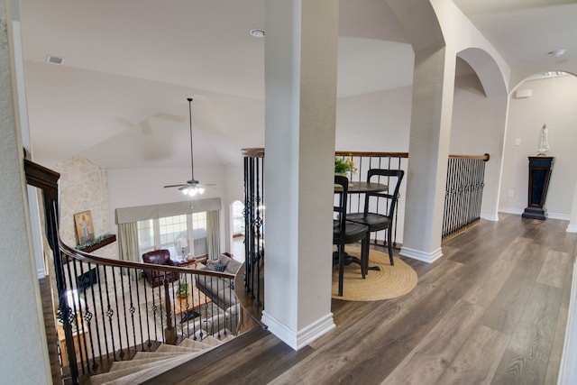 6001 Lacebark Elm Dr, Fort Worth, TX 76123 - corridor featuring wood finished floors, arched walkways, vaulted ceiling, baseboards, and an upstairs landing