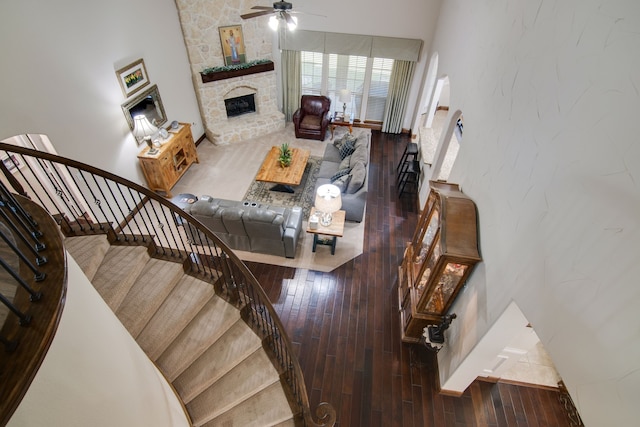 6001 Lacebark Elm Dr, Fort Worth, TX 76123 - living room featuring a fireplace, a ceiling fan, wood-type flooring, and stairway