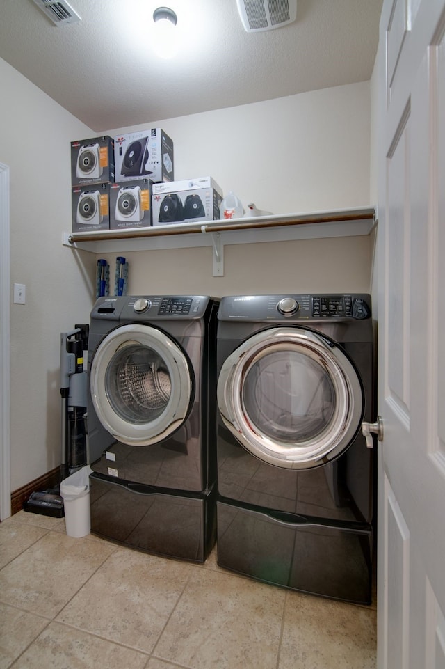 6001 Lacebark Elm Dr, Fort Worth, TX 76123 - laundry room with washer and clothes dryer and tile patterned floors