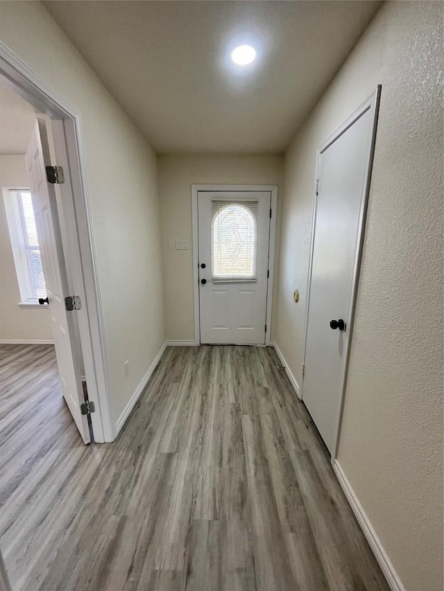 6706 Frontage Rd, Greenville, TX 75402 - doorway with wood finished floors and baseboards