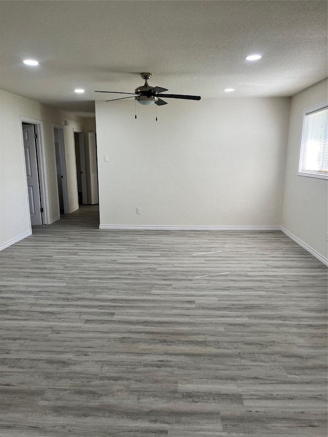 6706 Frontage Rd, Greenville, TX 75402 - empty room featuring wood finished floors, baseboards, a ceiling fan, recessed lighting, and a textured ceiling