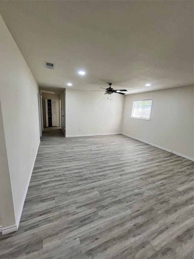 6706 Frontage Rd, Greenville, TX 75402 - unfurnished room with wood finished floors, baseboards, recessed lighting, and ceiling fan