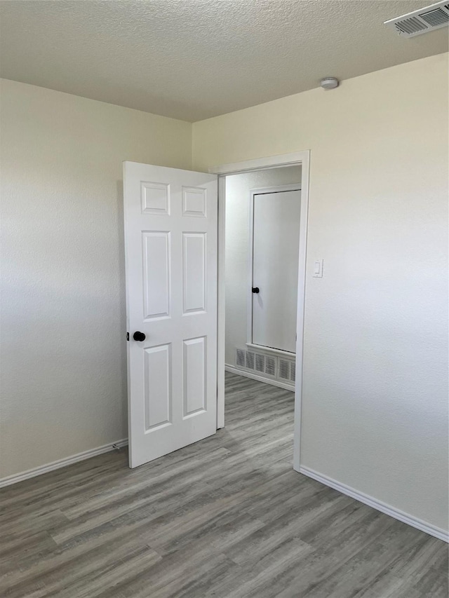 6706 Frontage Rd, Greenville, TX 75402 - empty room with baseboards, wood finished floors, and a smoke detector