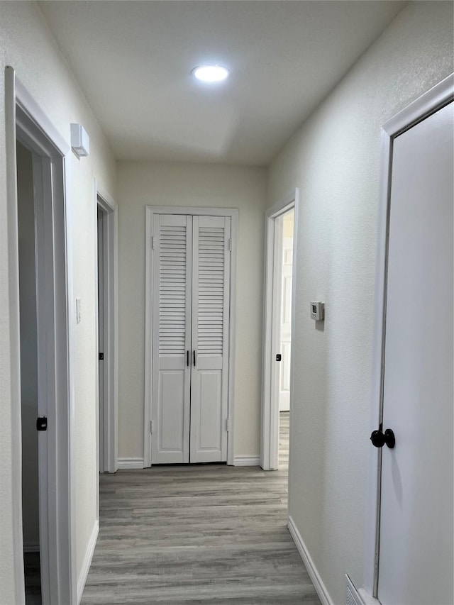 6706 Frontage Rd, Greenville, TX 75402 - corridor with wood finished floors, baseboards, and recessed lighting