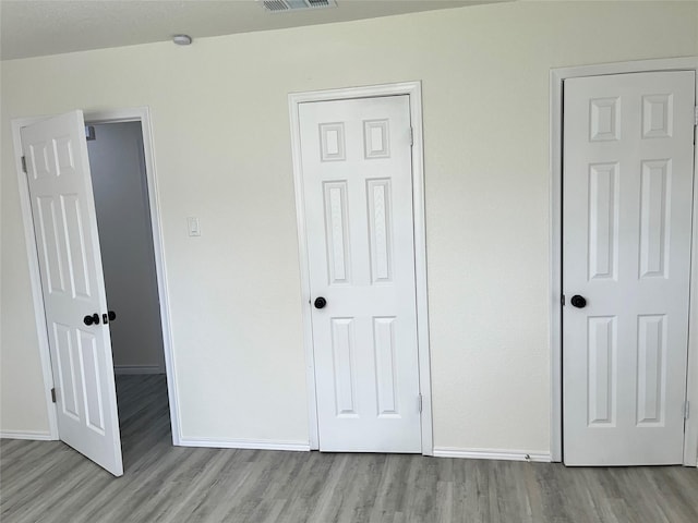 6706 Frontage Rd, Greenville, TX 75402 - unfurnished bedroom with wood finished floors and baseboards