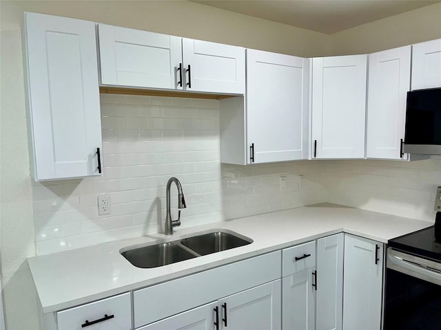 6706 Frontage Rd, Greenville, TX 75402 - kitchen featuring electric stove, a sink, tasteful backsplash, and white cabinetry