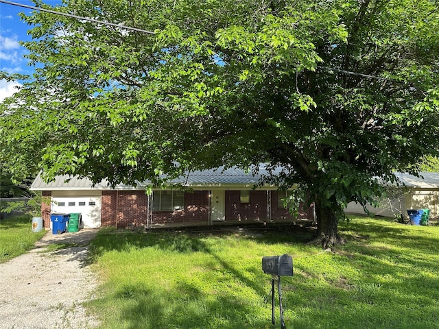 401 S Weatherford St, Chico, TX 76431 - view of front of home with brick siding, driveway, a garage, and a front yard